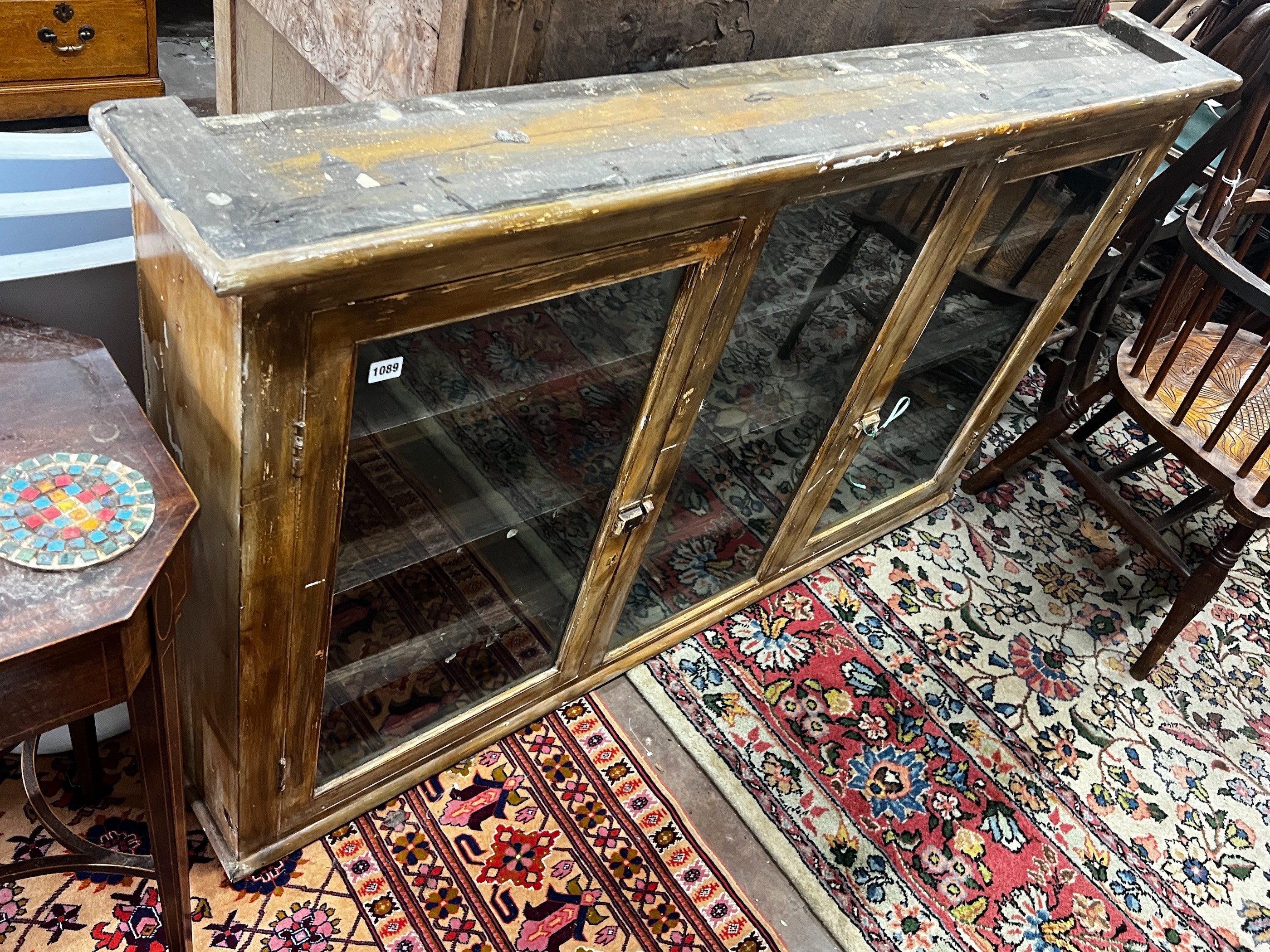 A late 19th / early 20th century painted glazed three door hanging cabinet, width 158cm, depth 22cm, height 96cm